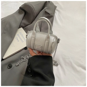Detailed view of silver mini boston bag with lychee texture and metal chain strap