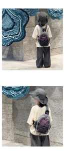 Detail of children's functional backpack with purple drawstring and matching sun hat