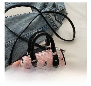 Détail d'un mini sac rose pour fille avec imprimés nœuds noirs et texture similicuir froncé