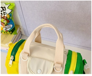 Top view of colorful kids cylindrical bag showing woven handles and zipper detail