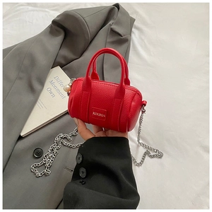 Close-up of red mini Boston bag with pearl zipper detail and silver chain strap