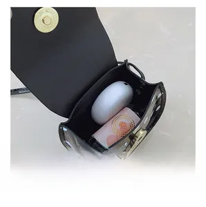 Internal storage detail of polka dot mini crossbody bag with metal magnetic clasp