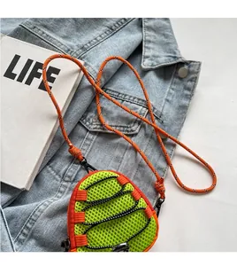 Detail of neon green mesh mini pouch with orange paracord strap on denim background