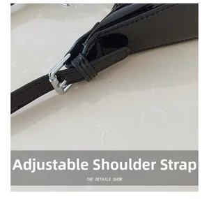 Detail of adjustable shoulder strap with silver metal buckle on black patent leather bag
