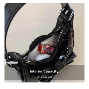 Detail view of the black bow handbag interior showing space for lipstick and earphones