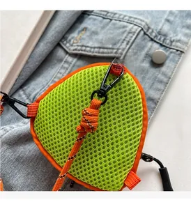 Close-up of neon green mesh mini pouch with orange trim and durable metal hook detail