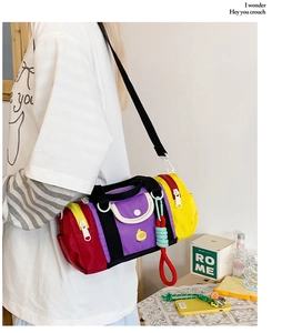 Detail shot of colorful color-block kids crossbody bag with cute yellow duck and wide strap