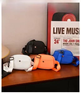 Detailed view of four colorful nylon crossbody bags for kids on a retro wooden table