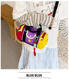 Detail of colorful patchwork cylinder crossbody bag with a cute yellow chick pattern