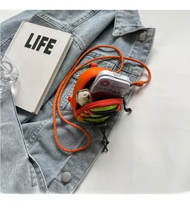 Mini crossbody pouch showing spacious interior with lipstick and essentials storage