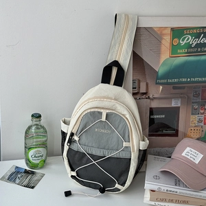 Close-up of sporty crossbody chest bag with drawstring detail and stylish contrast panels
