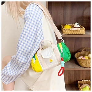 Detail of colorful canvas kids crossbody bag with multi-pocket design and duck patch