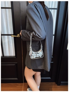 Side view of kid crossbody bag with laser mirror finish and large bow detail