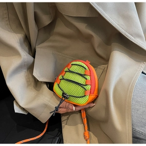 Close-up of mini neon green mesh neck bag with orange trim and drawstring detail