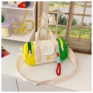 Detailed view of kids multi-colored canvas cylinder bag with cute duck embroidery