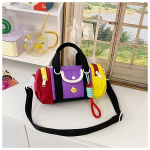 Detail of colorful patchwork cylinder bag with duck print and adjustable strap