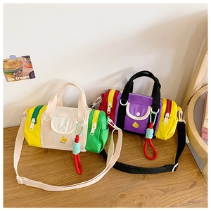 Detail of colorful canvas barrel bags with cute duck patterns and contrast zippers