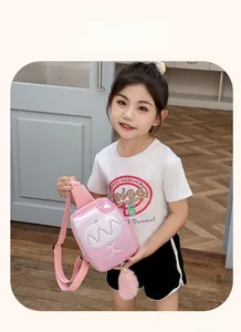 Detailed view of pink cartoon chest bag for kids with cute plush tail charm and 3D face