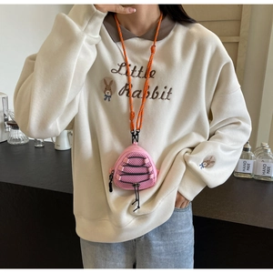 Close-up of pink mini neck pouch with orange rope strap worn on a white sweatshirt