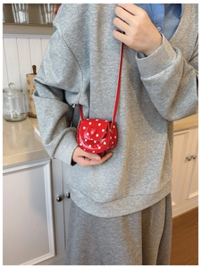 Polished red polka dot crossbody bag for girls with heart accent and slim strap