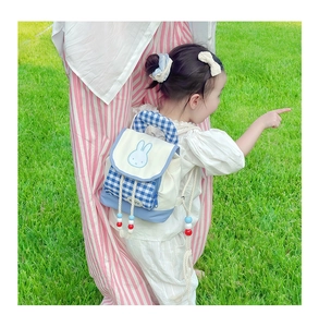 Close-up of a blue and white checkered kids backpack featuring miffy bunny embroidery