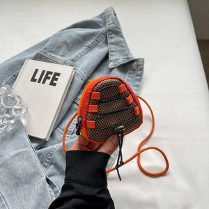 Detail of mini outdoor crossbody bag featuring orange mesh fabric and bungee cord toggles