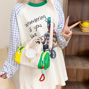 Colorful canvas crossbody cylinder bag for kids featuring a cute chick pattern and charms