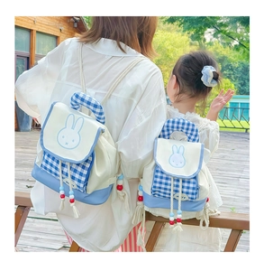 Detail of parent-child rabbit backpacks featuring blue plaid pattern and cute miffy motif