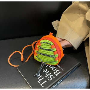 Close-up of mini outdoor coin purse with neon green mesh and orange trekking rope detail