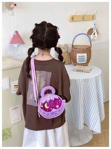 Detail der lila Kinder-Umhängetasche im Mond-Design, getragen von einem Kindermodel