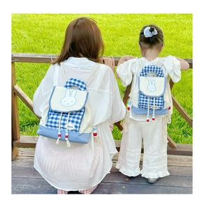 Detail of parent-child backpack set with blue plaid pattern and rabbit embroidery
