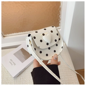 Detailed view of kids polka dot crossbody bag featuring a 3D heart and glossy finish