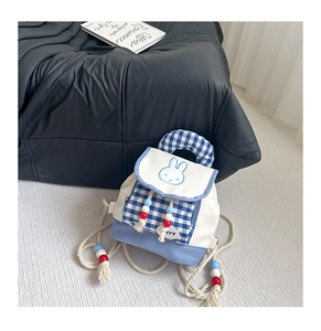 Close-up of cute rabbit embroidery on checkered toddler backpack with tassel details