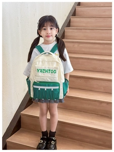 Close-up of kids contrast color backpack with YXCHTOG lettering and drawstring detail