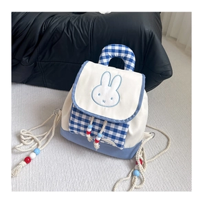 Detail of blue gingham toddler backpack with rabbit embroidery and beaded tassels