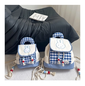 Detail of blue plaid Miffy backpacks with hemp rope handles and wooden bead accents