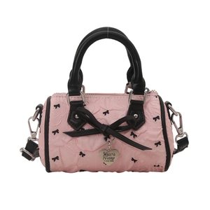 Mini sac cylindrique rose avec nœud noir, anses en cuir et pendentif cœur en métal