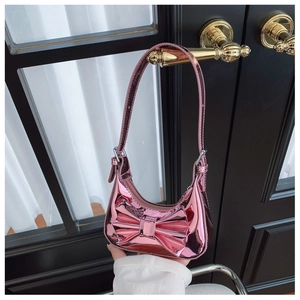 Close-up of pink laser mirror finish kids shoulder bag with large bow decoration