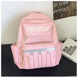 Close-up of pink school backpack with reflective safety strips and U-shaped decorative cord