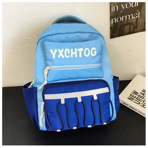 Detail of color-block backpack with blue nylon fabric and functional zipper pockets