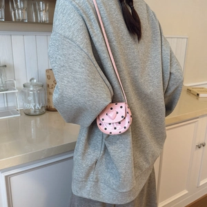 Pink heart-shaped buckle mini crossbody bag with black polka dots for toddlers