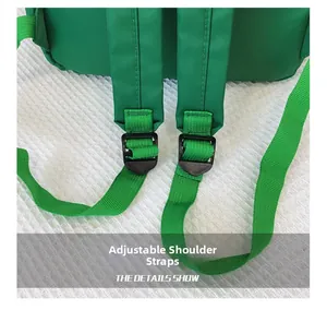 Detail of adjustable green woven shoulder strap with black buckle for school backpack