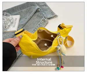 Interior view showing main compartment and zipper pocket of a yellow nylon crossbody bag