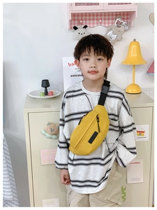 Dettaglio del marsupio giallo per bambini in tela con tracolla regolabile nera in nylon