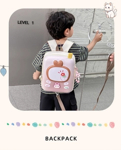 Detailed view of pink gradient hardshell kids backpack with rabbit and floral charms