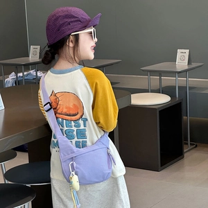Kids casual purple canvas crossbody bag with matching plaid cap and yellow long sleeve tee