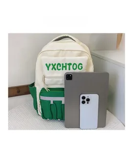 Size comparison of color-block student backpack next to an iPad and smartphone