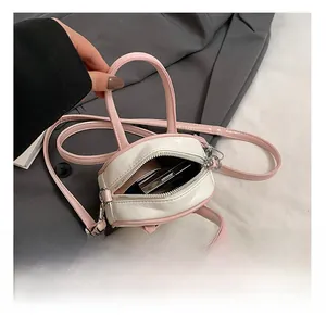 Detailed interior view of a pink mini crossbody bag showing small storage capacity