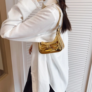 Kids metallic gold bow handbag featuring laser mirror finish and slim shoulder strap