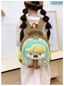 Détail du sac à dos ours vert avec pattes en peluche et poche latérale en filet